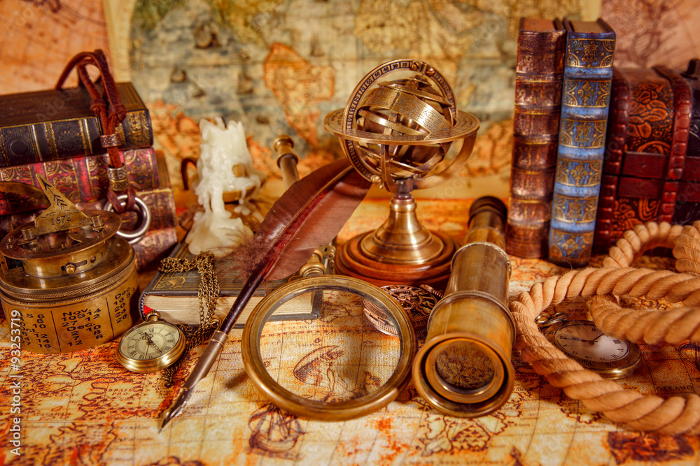 Vintage magnifying glass lies on an ancient world map - obrazy, fototapety, plakaty 