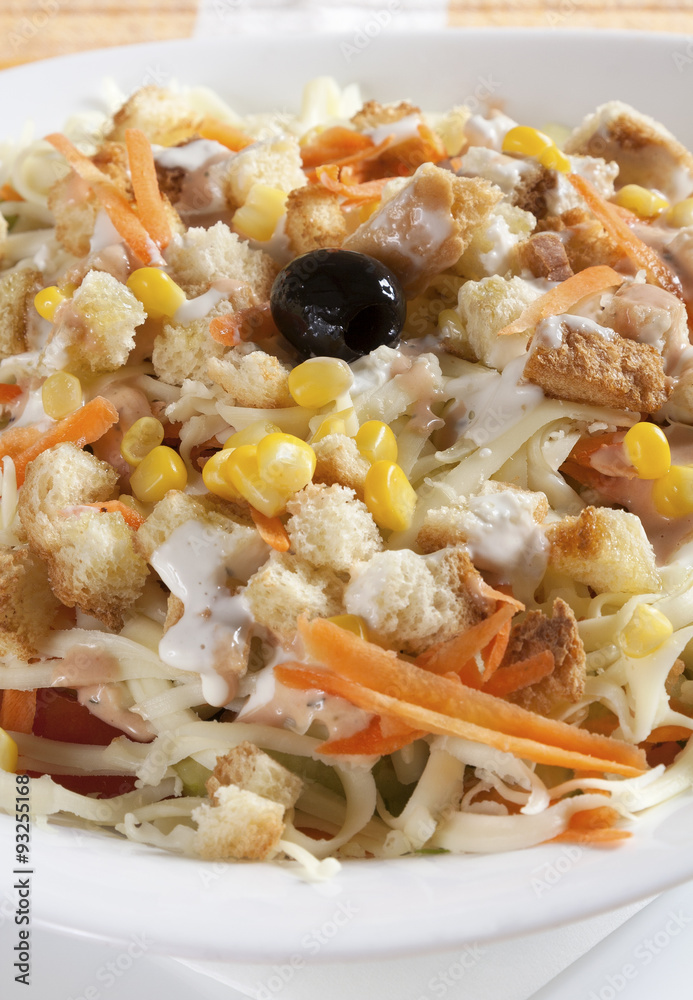 Delicious salad of fresh vegetables with ham, cheese and egg, served in a white bowl. Delicious salad of fresh vegetables with ham, cheese and egg, served in a white bowl.