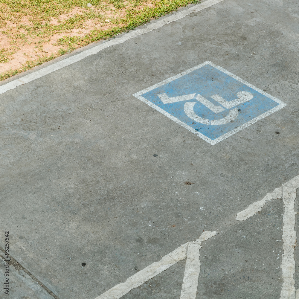 Fototapeta premium parking space reserved handicapped on road with disabled sign