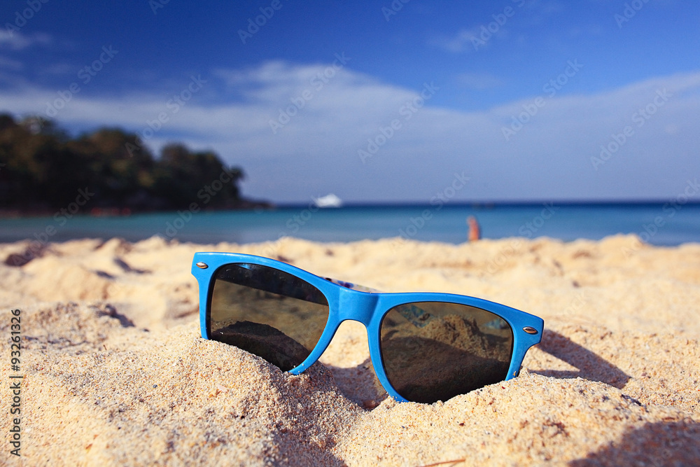 sunglasses on a sandy beach concept Summer