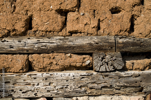 Wall of old adobe house photo