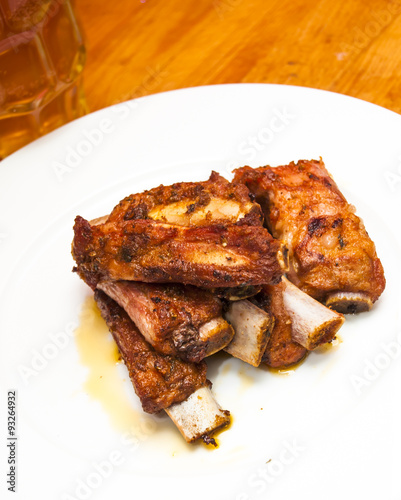Roasted pork ribs on a white plate