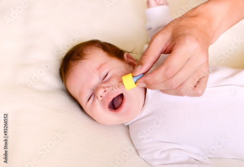 newborn baby gets nose drops