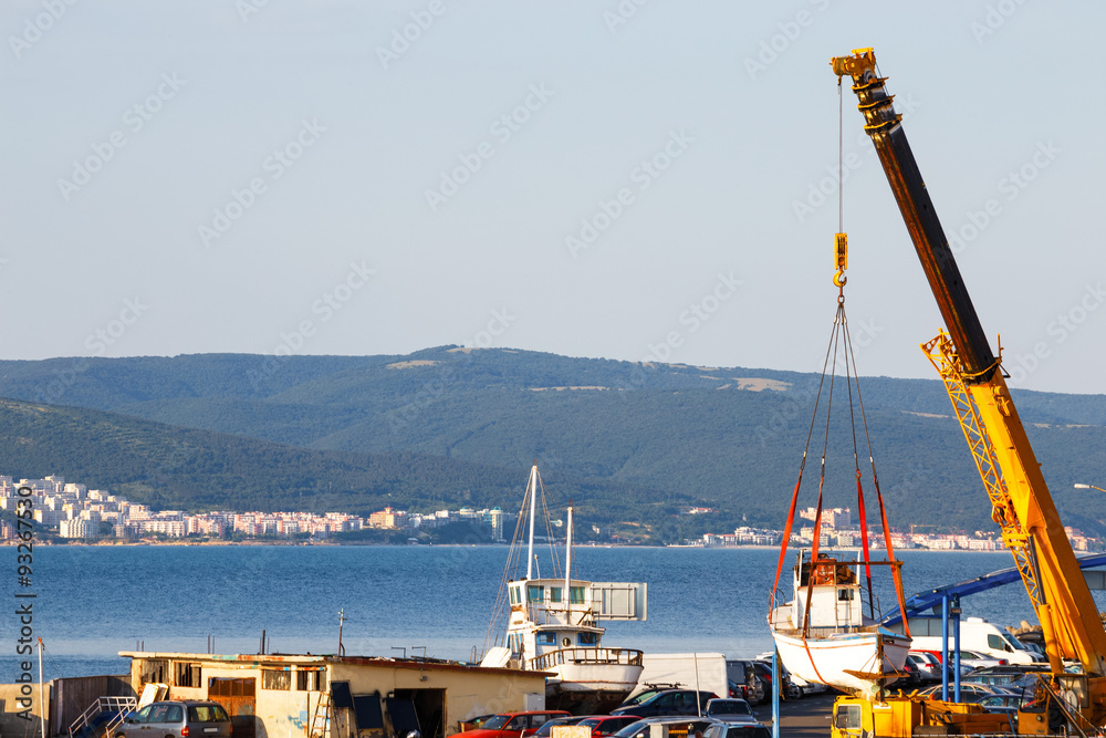 Moving of boat with crane in a port