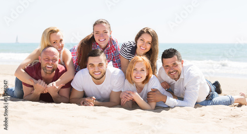 Friends laying on sand