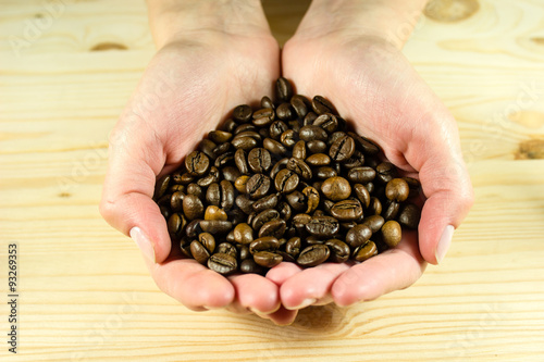 Coffee beans in hands photo