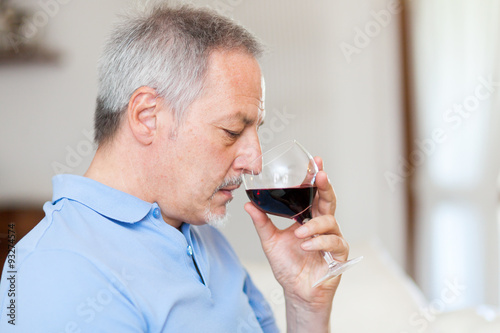 Mature man enjoying a glass of red wine