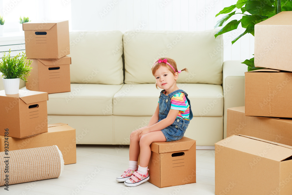 moving to new apartment. happy child and cardboard box moving to new apartment. happy child and cardboard box