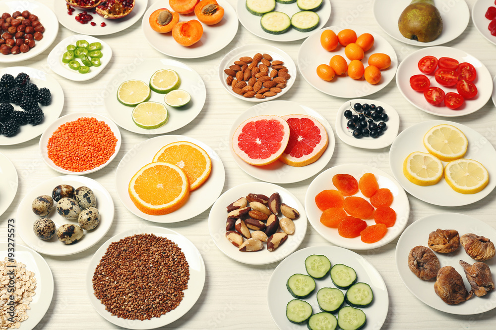 Different products on saucers on wooden table, top view Different products on saucers on wooden table, top view