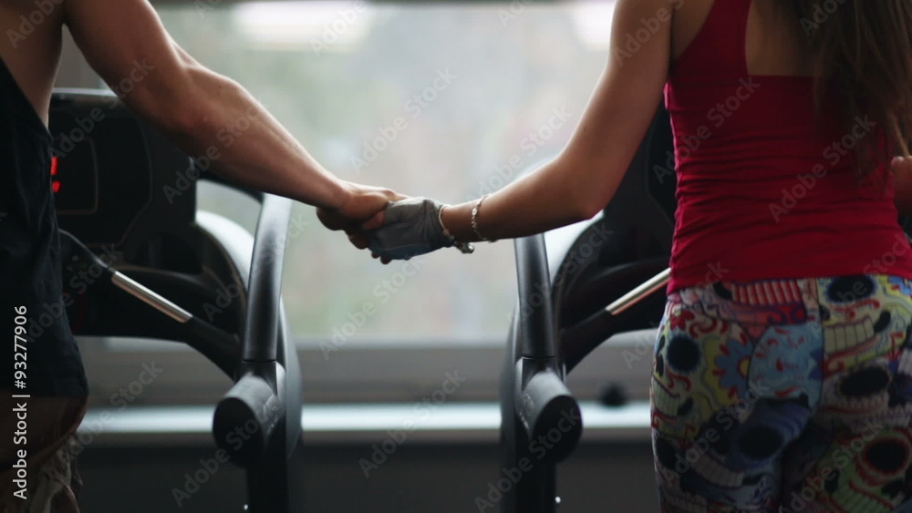 Fit woman lifting dumbbells with trainer at a crossfit gym Fit woman lifting dumbbells with trainer at a crossfit gym
