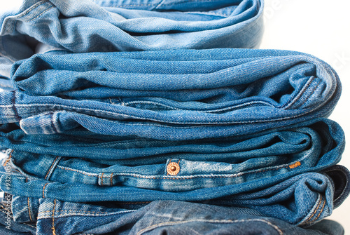Jeans stacked on a white background - studio shot