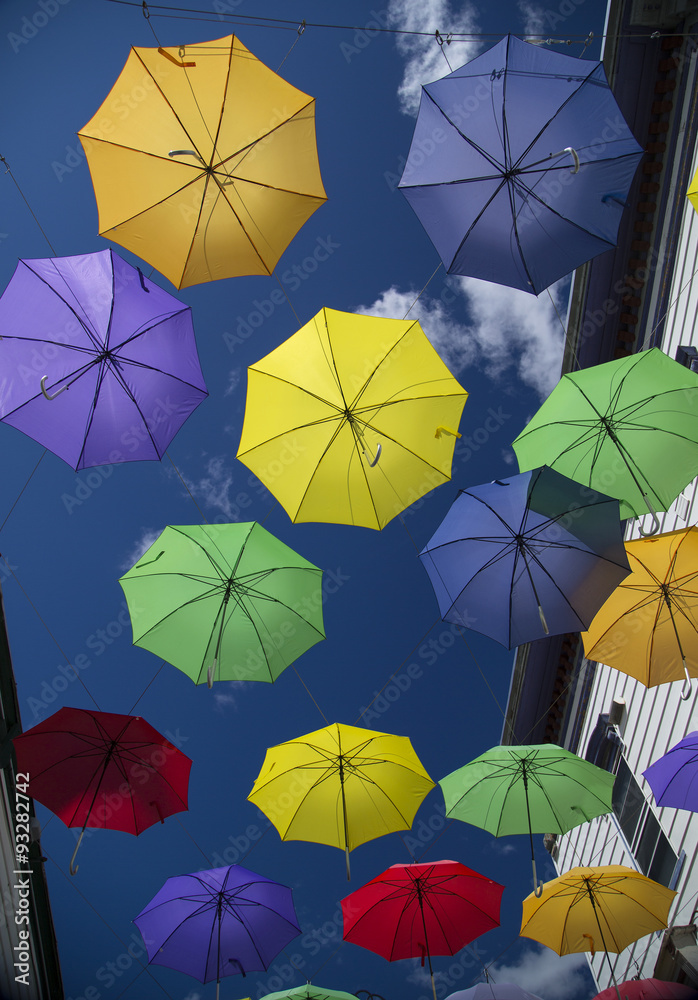 Colorful Umbrellas Suspended in Alleyway Colorful Umbrellas Suspended in Alleyway