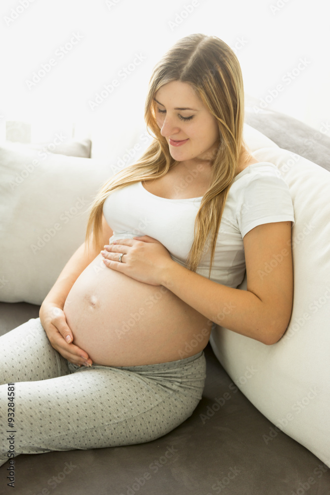 pregnant woman relaxing on sofa and looking on belly pregnant woman relaxing on sofa and looking on belly