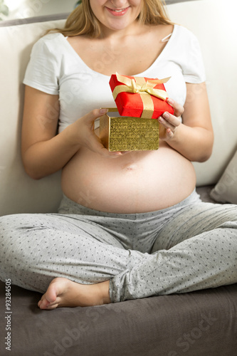 pregnant woman looking inside of gift box