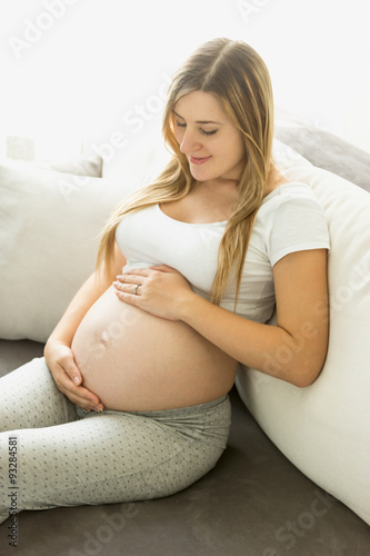 pregnant woman relaxing on sofa and looking on belly Free Download pregnant woman relaxing on sofa and looking on belly - GFXLoad