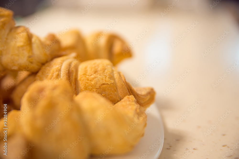 Fototapeta premium Delicious croissants on plate on table close-up