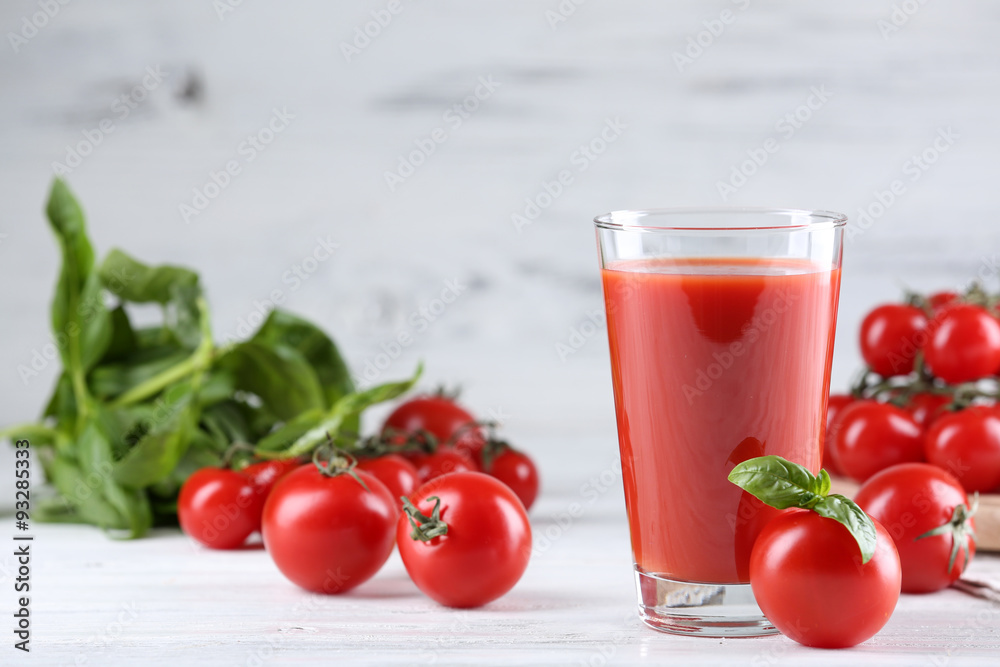 Glass of tomato juice with vegetables on wooden table close up Glass of tomato juice with vegetables on wooden table close up