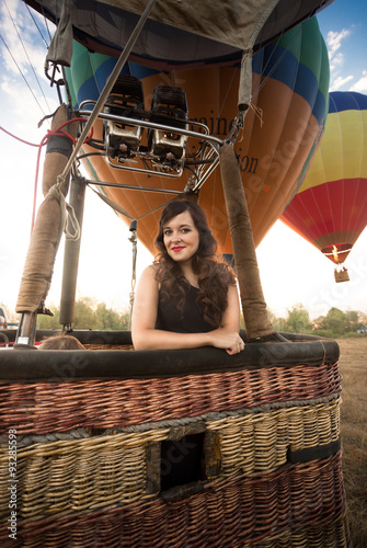 Portrait of beautiful woman posing at hot air balloon basket