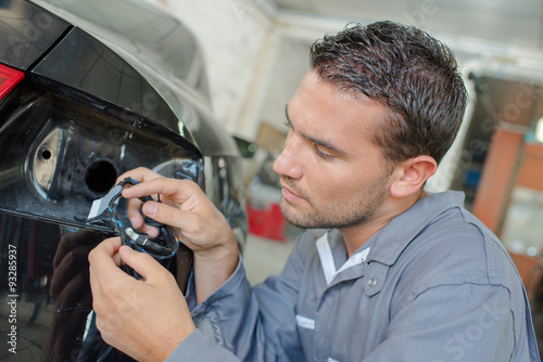 Mechanic changing a bulb