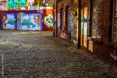 Looking down a long colorful alley © tomikk