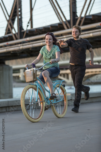 Young Man Chases Girl on Bike