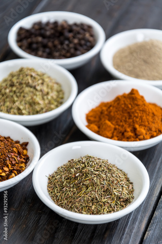 Spices and herbs in  bowls.