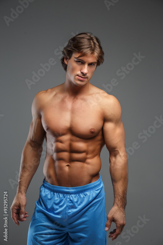 Strong muscular man in blue shorts.