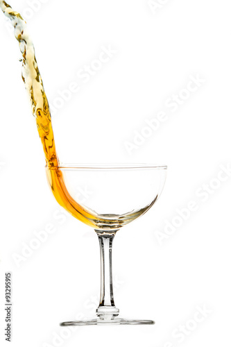elegant  glass with splash of drink, amber colored liquid