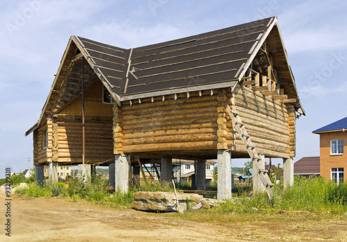 Construction a wooden house on stilts.
