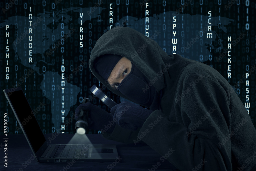 Burglar staring at the camera while stealing user identity Burglar staring at the camera while stealing user identity