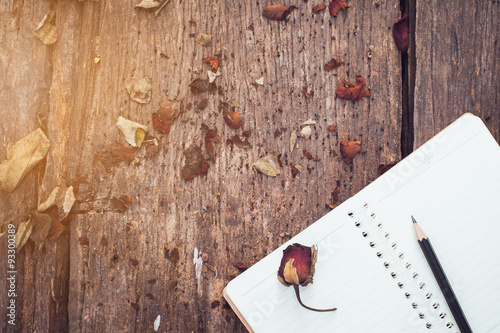 notebook,pencil and dried roses