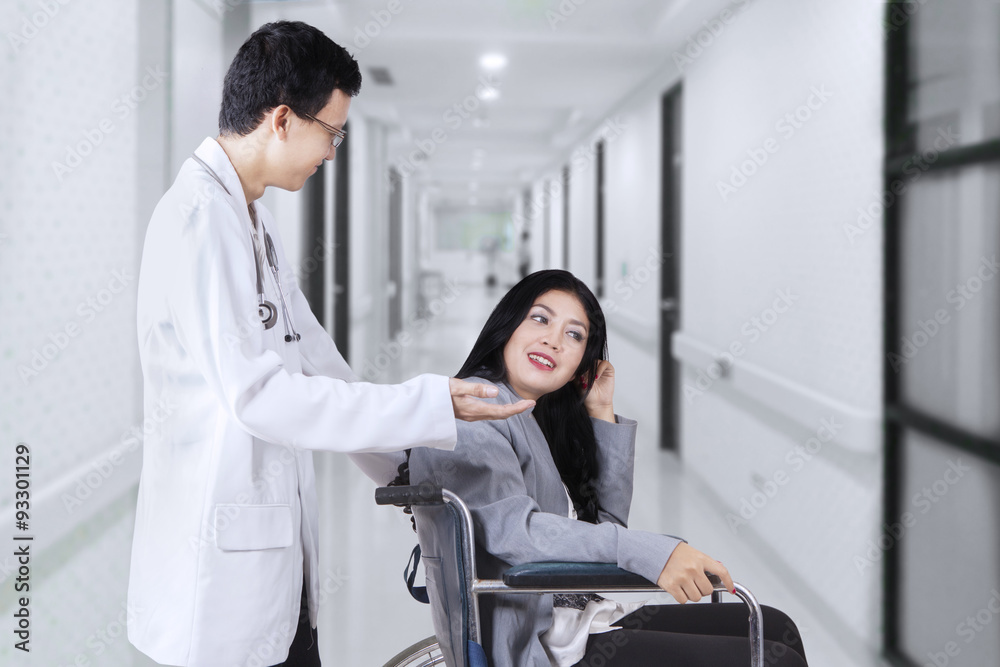 Fototapeta premium Doctor talking with disabled patient in hospital