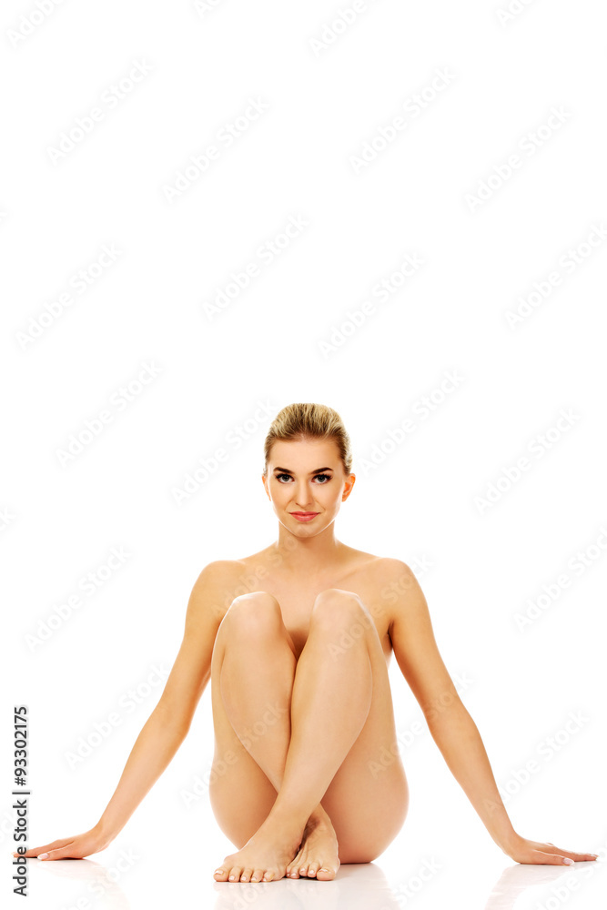 Young naked woman sitting on the floor Young naked woman sitting on the floor