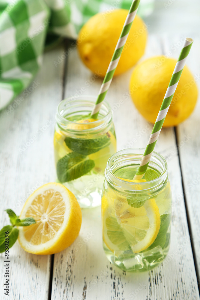 Fresh lemonade with lemon on white wooden background Fresh lemonade with lemon on white wooden background