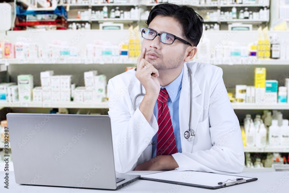 Pensive pharmacist in the drugstore