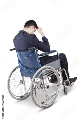 Stressful man sitting on the wheelchair © Creativa Images
