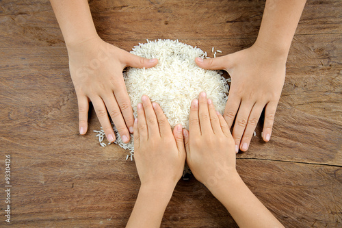 Rice grain on kid hand photo