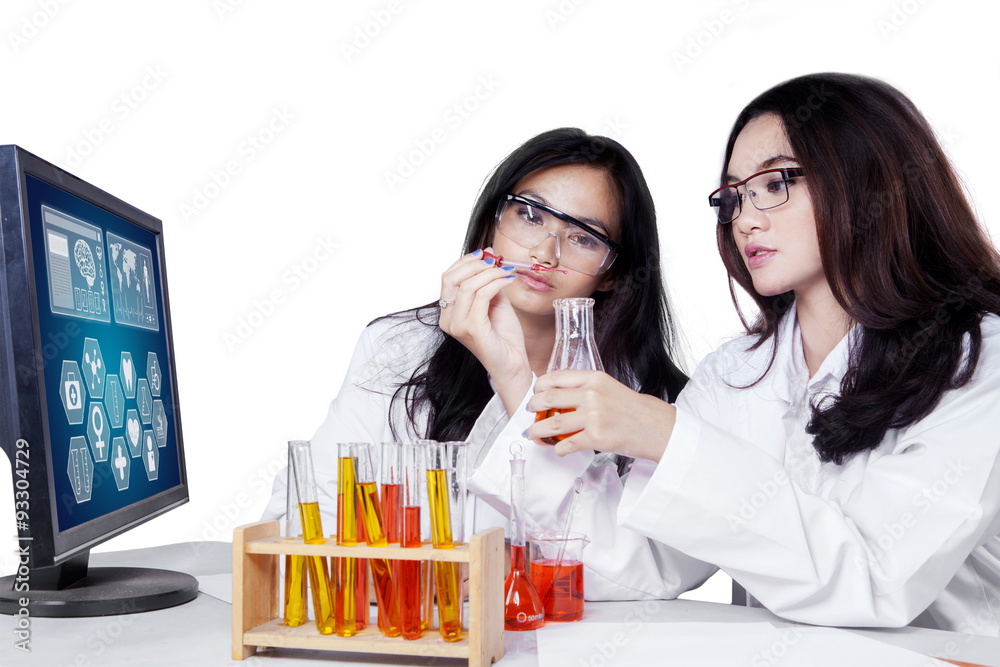 Young scientists working with chemical liquid Young scientists working with chemical liquid