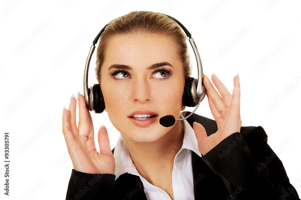Young woman helpline operator is trying to hear something Young woman helpline operator is trying to hear something