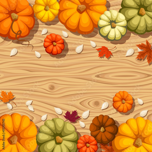 Pumpkins on a wooden background. Vector seamless background.