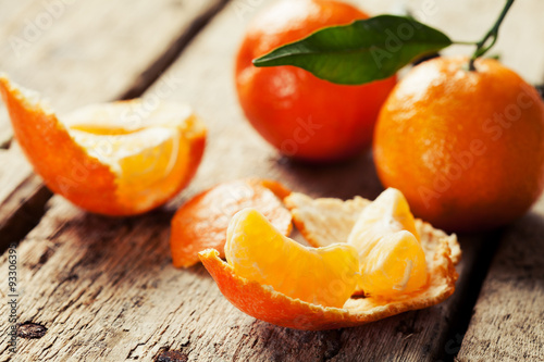 Open tangerine on wooden background
