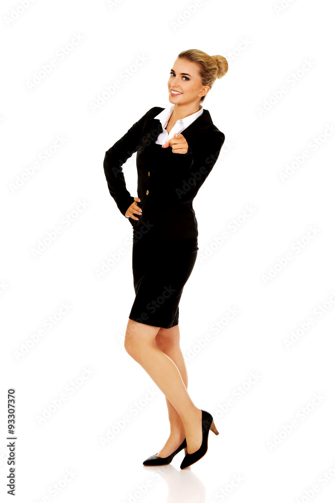 Young smiled businesswoman pointing her finger Young smiled businesswoman pointing her finger