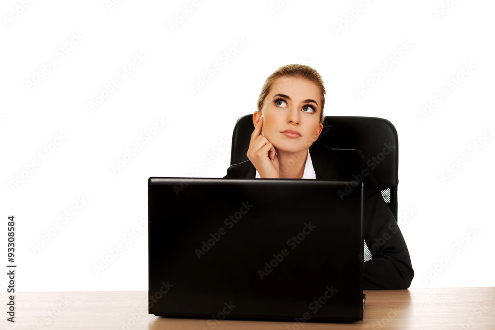 Young businesswoman behind the desk, using laptop Young businesswoman behind the desk, using laptop