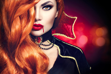 Halloween vampire woman portrait. Beautiful glamour fashion sexy vampire