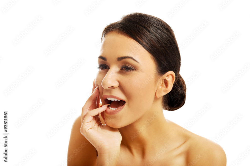 Happy beautiful woman holding finger in mouth Happy beautiful woman holding finger in mouth