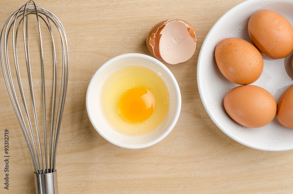 Fresh egg yolk in the bowl on wooden background,food ingredient Fresh egg yolk in the bowl on wooden background,food ingredient
