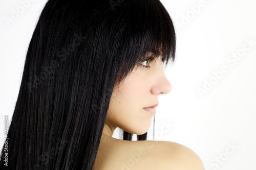 Hair. Extreme closeup profile of brunette model with black hair