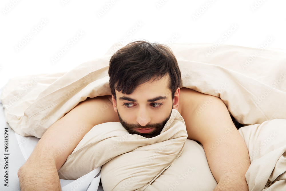Man waking up in bedroom. Man waking up in bedroom.