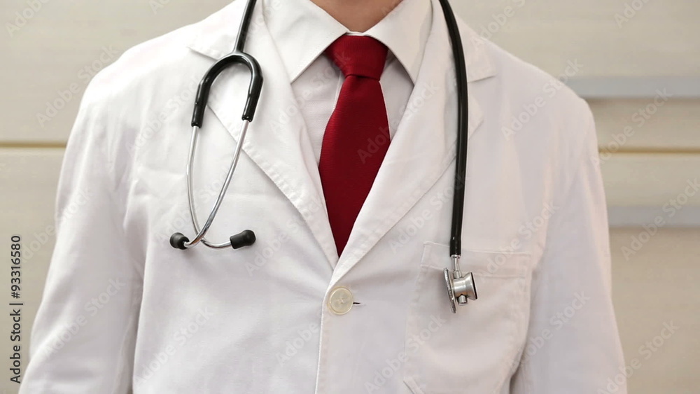 Upper shot of a doctors torso, camera moving from left to right Upper shot of a doctors torso, camera moving from left to right