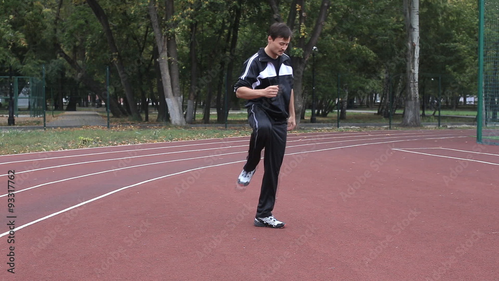 Runner warming up legs flexing Runner warming up legs flexing